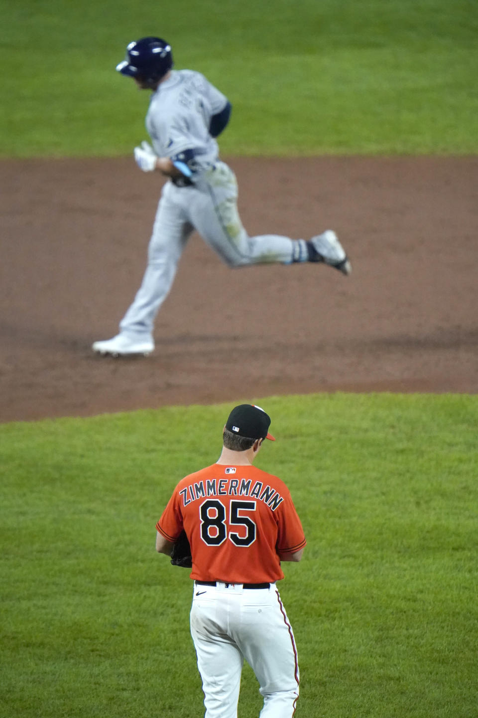 Baltimore Orioles starting pitcher Bruce Zimmerman (85) walks behind the mound after allowing a solo home run to Tampa Bay Rays' Hunter Renfroe, top, during the third inning of the second game of a baseball doubleheader, Thursday, Sept. 17, 2020, in Baltimore. (AP Photo/Julio Cortez)