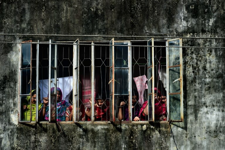 Bangladeshi onlookers gather near the house where police killed nine suspected Islamist extremists in Dhaka on July 26, 2016