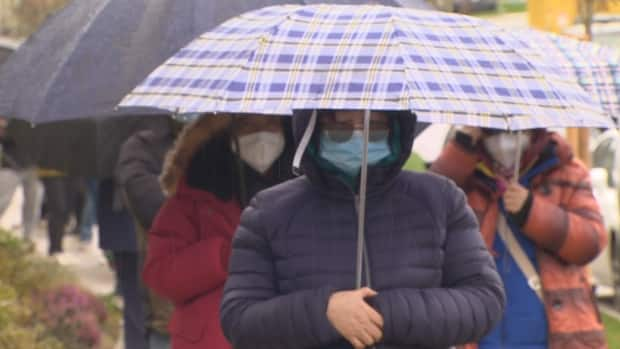 People form a line in Langley, B.C., on Saturday hoping to purchase a townhome. (Doug Kerr/CBC News - image credit)