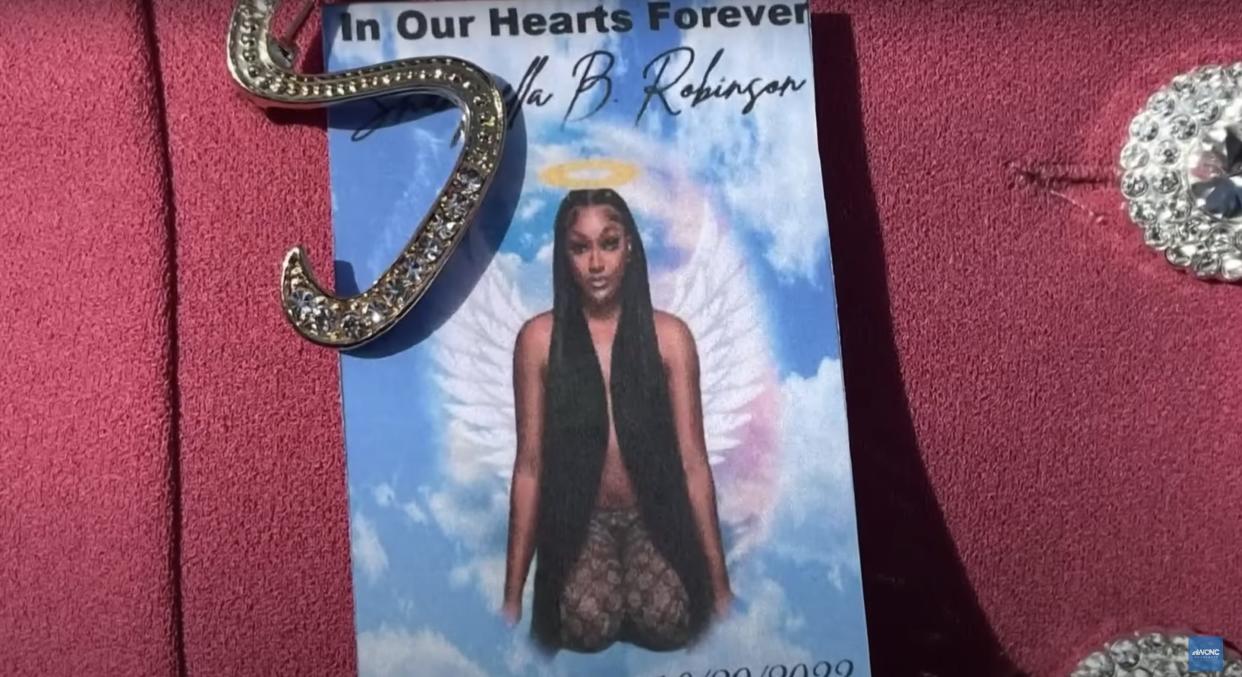 a picture of Shanquella Robinson is pinned to a coat during her funeral