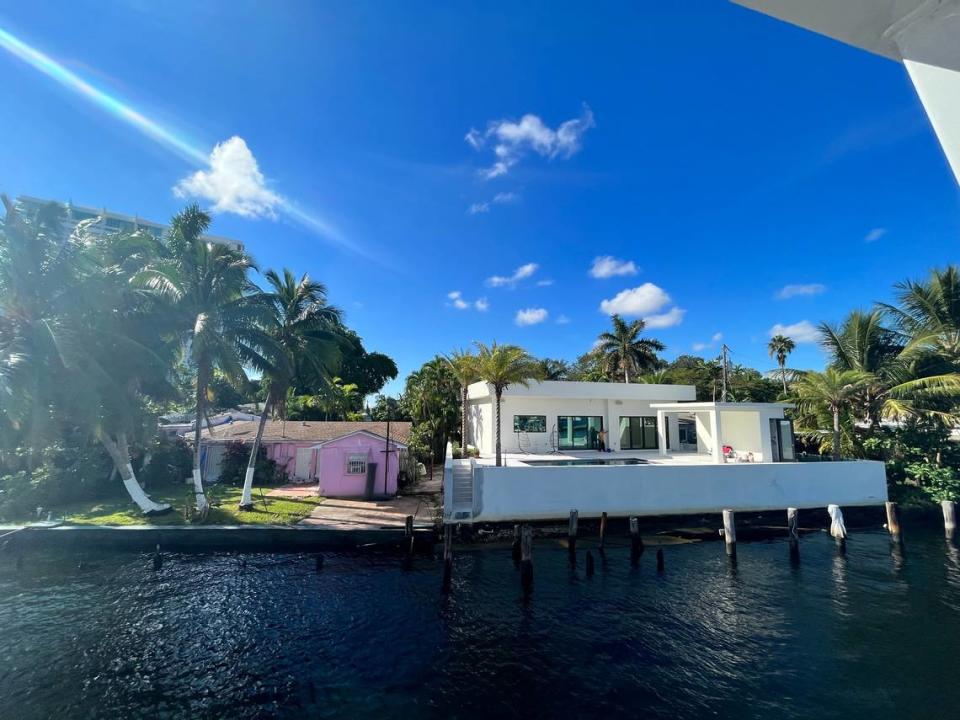 Two next-door homes along the Miami River show the impact of new building and elevation standards compared to older stock housing. Both homes are only one story, but the newer house appears nearly twice as tall as the older one.