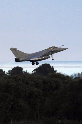 A French Rafale Jet fighter of the French armys prepares to land at the aerial military base of Solenzara in Corsica. French air raids and US Tomahawk missiles pounded targets in Libya on Saturday, in an international campaign to prevent Moamer Kadhafi from crushing a month-old uprising against his rule