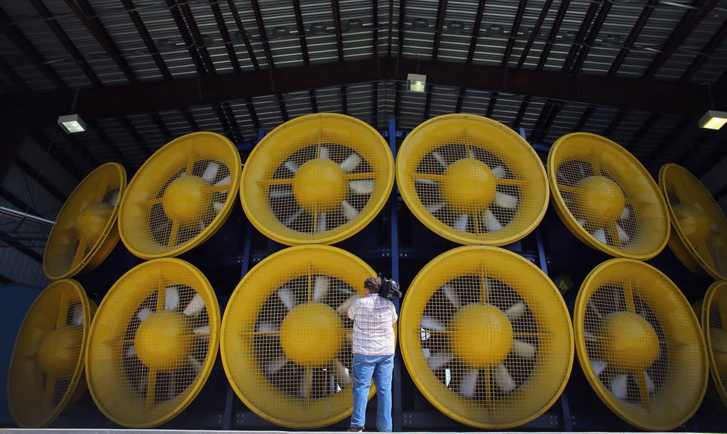 A videographer stands in front of 12 fans, that create what is called a Wall of Wind, at the Florida International University engeneering centre  (Getty)