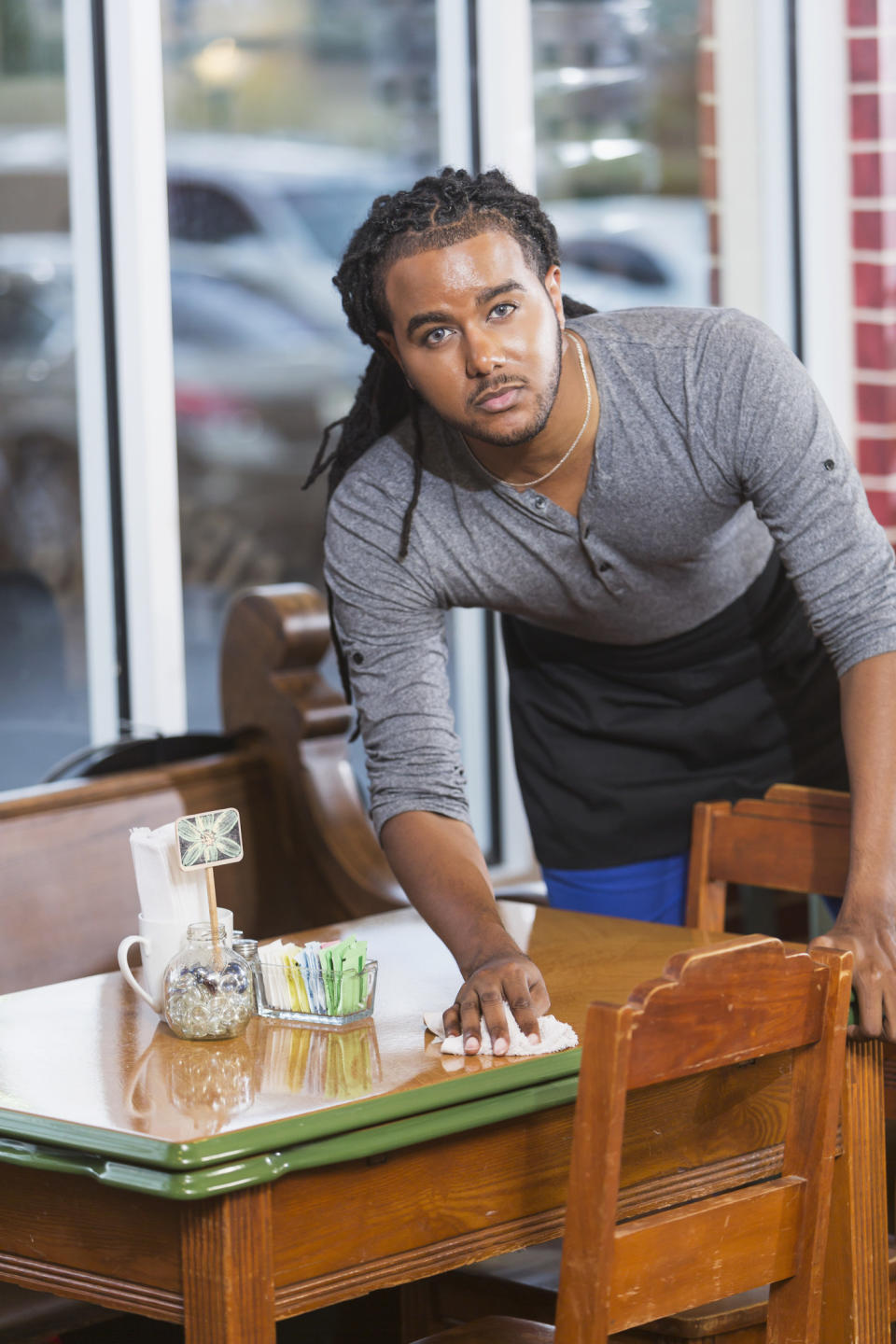 a person cleaning a table