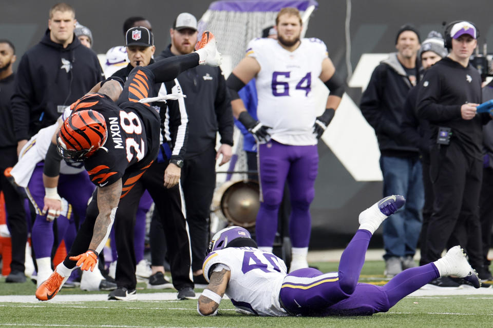 Cincinnati Bengals running back Joe Mixon (28) leaps over Minnesota Vikings linebacker Ivan Pace Jr. (40) during the second half of an NFL football game Saturday, Dec. 16, 2023, in Cincinnati. (AP Photo/Jay LaPrete)