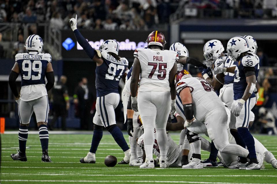 Dallas Cowboys defensive tackle Osa Odighizuwa (97) celebrates after the Cowboys make a stop on the Washington Commanders. Mandatory Credit: Jerome Miron-USA TODAY Sports
