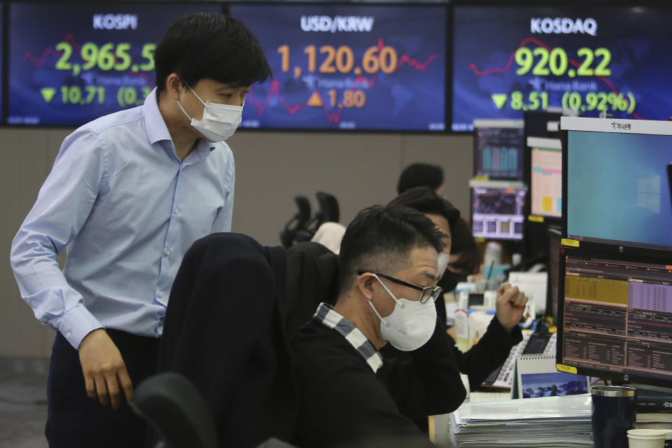 Currency traders watch monitors at the foreign exchange dealing room of the KEB Hana Bank headquarters in Seoul, South Korea, Monday, Feb. 1, 2021. Asian stock markets gained Monday after coronavirus vaccine maker AstraZeneca agreed to increase supplies to Europe amid rising worries about the disease. (AP Photo/Ahn Young-joon)