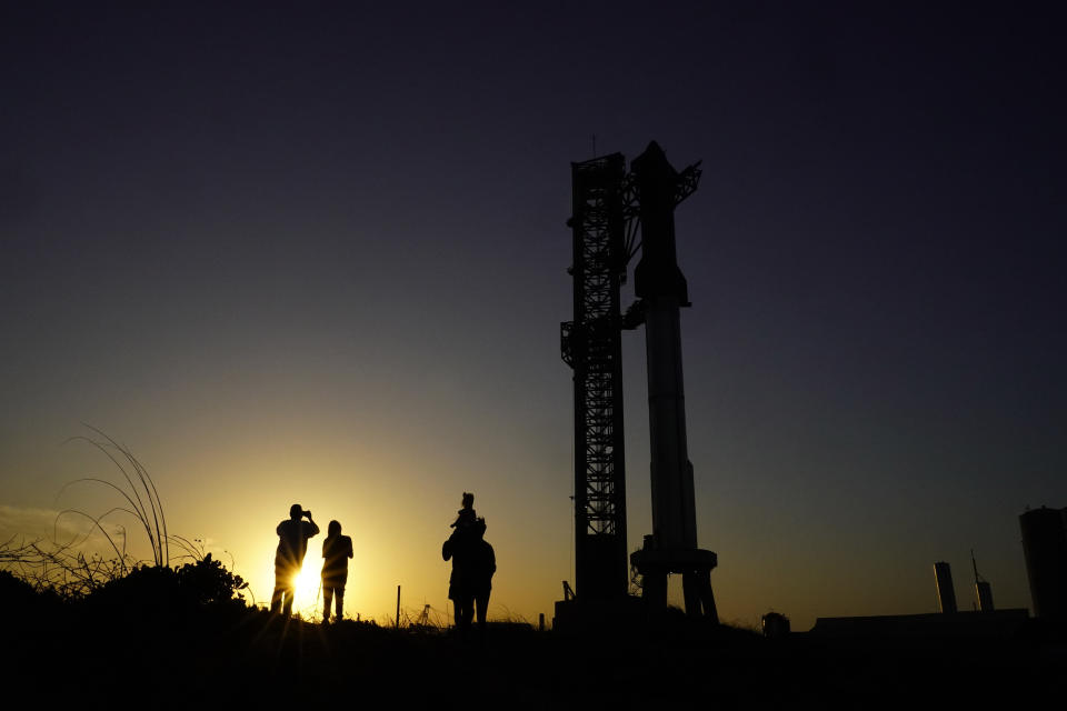 Onlookers watch as SpaceX's Starship, the world's biggest and most powerful rocket, stands ready for launch in Boca Chica, Texas, late Sunday, April 16, 2023. The test launch is scheduled for Monday. (AP Photo/Eric Gay)