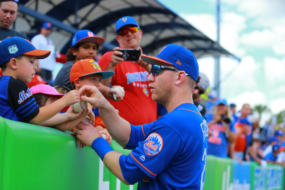 <p>New York Mets player Todd Frazier signs for young fans before the baseball game against the Miami Marlins at First Data Field in Port St. Lucie, Fla., Feb. 25, 2018. (Photo: Gordon Donovan/Yahoo News) </p>