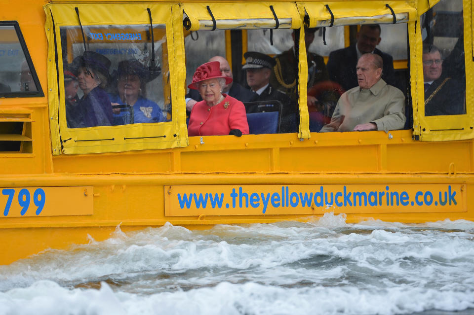 Queen Elizabeth II and Prince Philip, Duke of Edinburgh take a ride on the Yellow Duck and amphibious vehicle during a visit to Merseyside Maritime Museum on May 17, 2012 in Liverpool, England. 