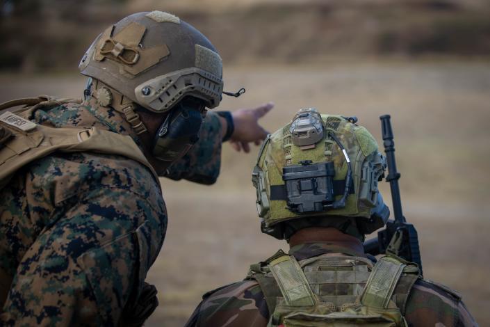 U.S. Marine Corps Sgt. Timothy M. Kaufusi, left, team leader, 3rd Marine Littoral Regiment, 3rd Marine Division, assists a Tongan Marine from his Majesty’s Armed Forces while conducting a live fire exercise during Rim of the Pacific 2022 on July 12. (Lance Cpl. Haley Fourmet Gustavsen/US Marine Corps)