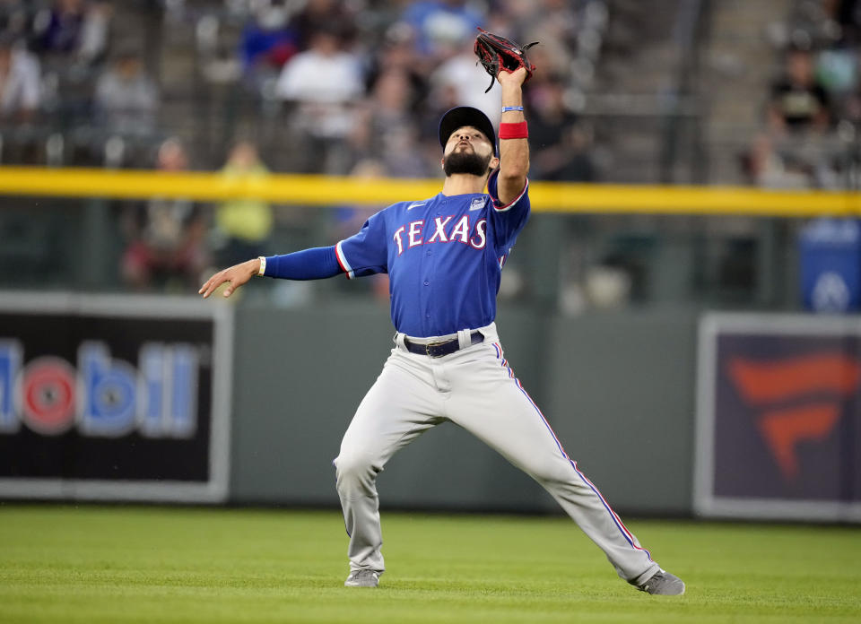 Texas Rangers shortstop Isiah Kiner-Falefa pulls in a shallow fly ball off the bat of Colorado Rockies' Charlie Blackmon to end the fifth inning of a baseball game Wednesday, June 2, 2021, in Denver. (AP Photo/David Zalubowski)