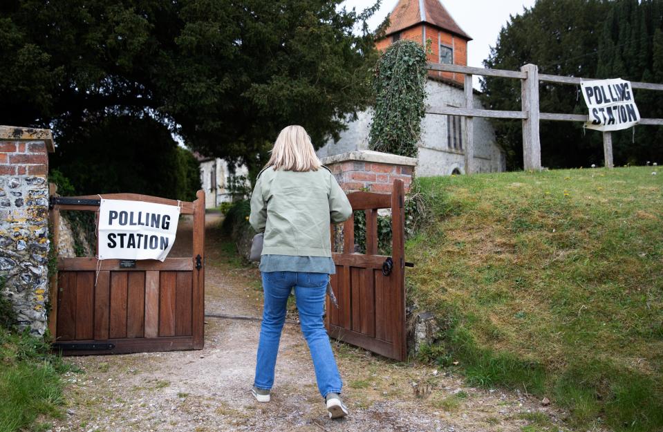 Woman at polling station (PA Wire)