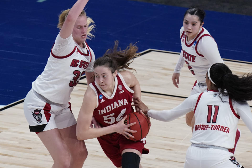 Indiana forward Mackenzie Holmes (54) drives past North Carolina State center Elissa Cunane (33) during the first half of a college basketball game in the Sweet Sixteen round of the women's NCAA tournament at the Alamodome in San Antonio, Saturday, March 27, 2021. (AP Photo/Eric Gay)