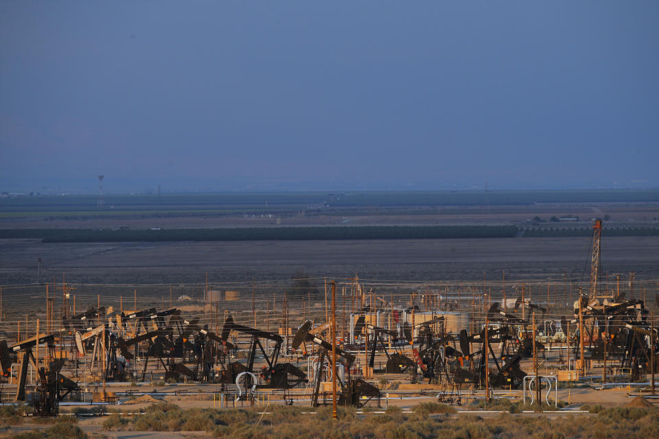 FILE - This May 1, 2018 file photo shows oil pump jacks in an oil field near Taft, Calif. California's oil rich Kern County is voting on a revised plan that could permit tens of thousands of oil and gas wells in the next two decades. The plan had to be rewritten after environmental groups sued and a state appeals court found the county's permit system could threaten the region's air and water. (AP Photo/Jae C. Hong,File)