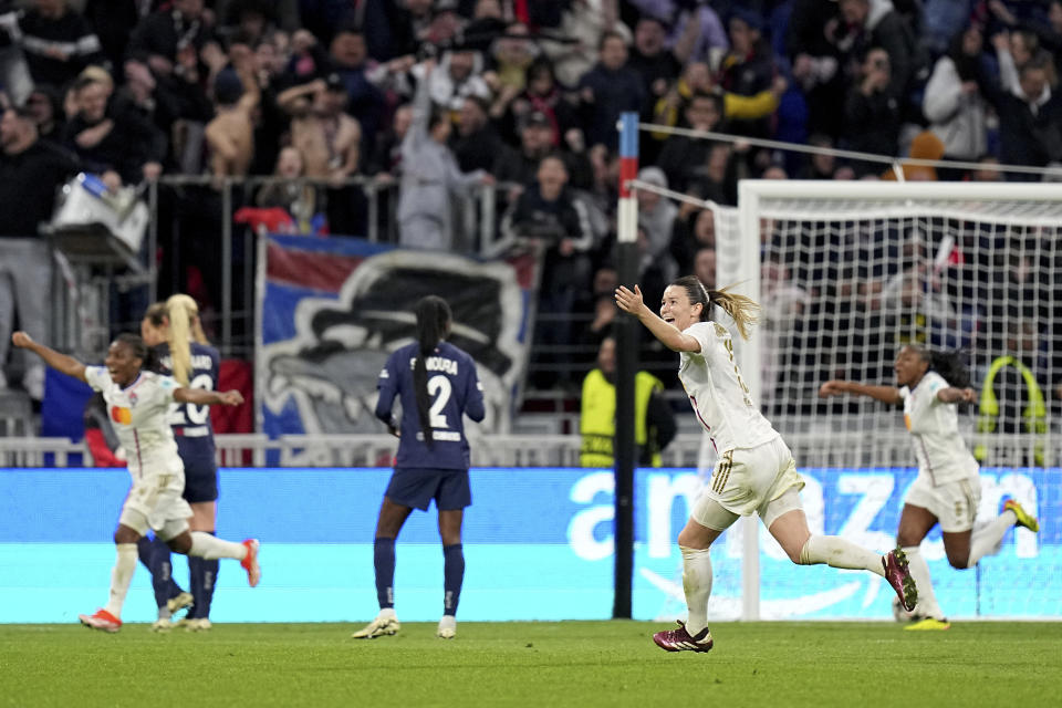 Lyon's Damaris Egurrola, foreground, celebrates after teammate Amel Majri scored their side's third goal during the women's Champions League semifinals, first leg, soccer match between Olympique Lyonnais and Paris Saint-Germain at Parc Olympique Lyonnais, in Lyon, France, Saturday, April 20, 2024. (AP Photo/Laurent Cipriani)