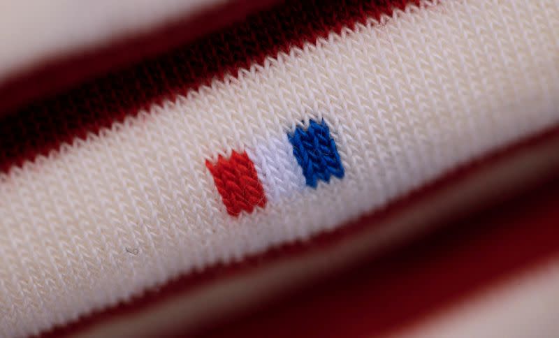 FILE PHOTO: A French flag is seen on a pair of socks displayed at the "Made In France" fair in Paris