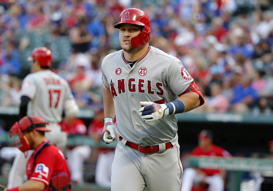 Los Angeles Angels' Mike Trout jogs to the dugout after hitting a solo home run off Texas Rangers' Lance Lynn during the first inning of a baseball game in Arlington, Texas, Thursday, July 4, 2019. (AP Photo/Tony Gutierrez)