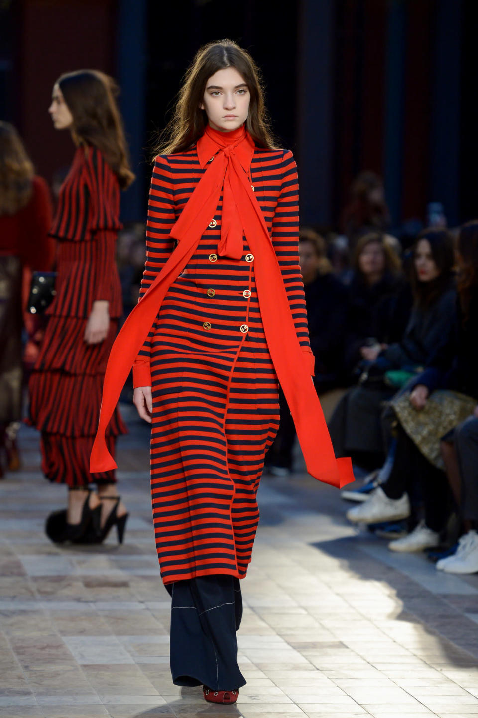 A model walks the runway in a striped overcoat during the fall 2016 Sonia Rykiel show in Paris.