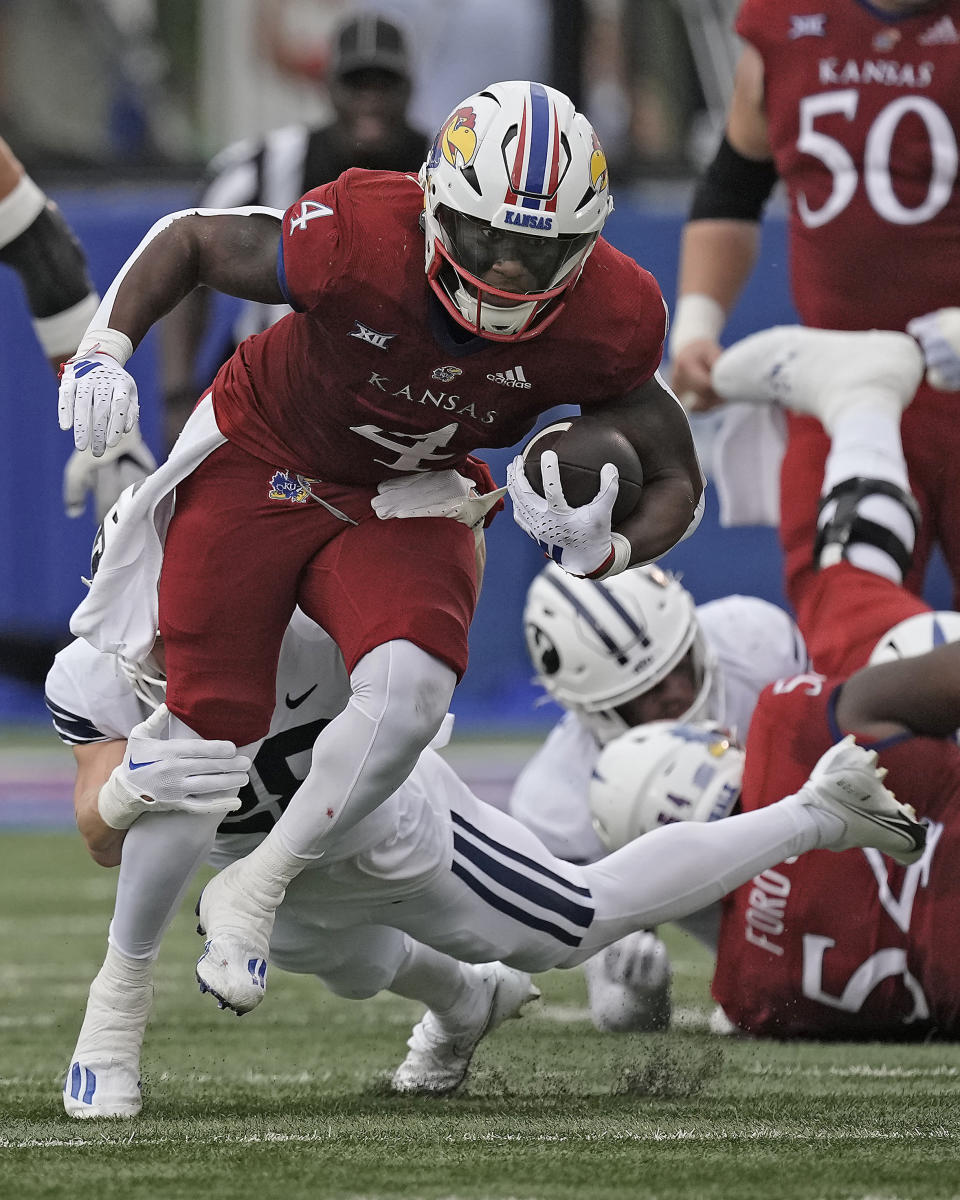 Kansas running back Devin Neal (4) runs the ball during the first half of an NCAA college football game against BYU Saturday, Sept. 23, 2023, in Lawrence, Kan. (AP Photo/Charlie Riedel)