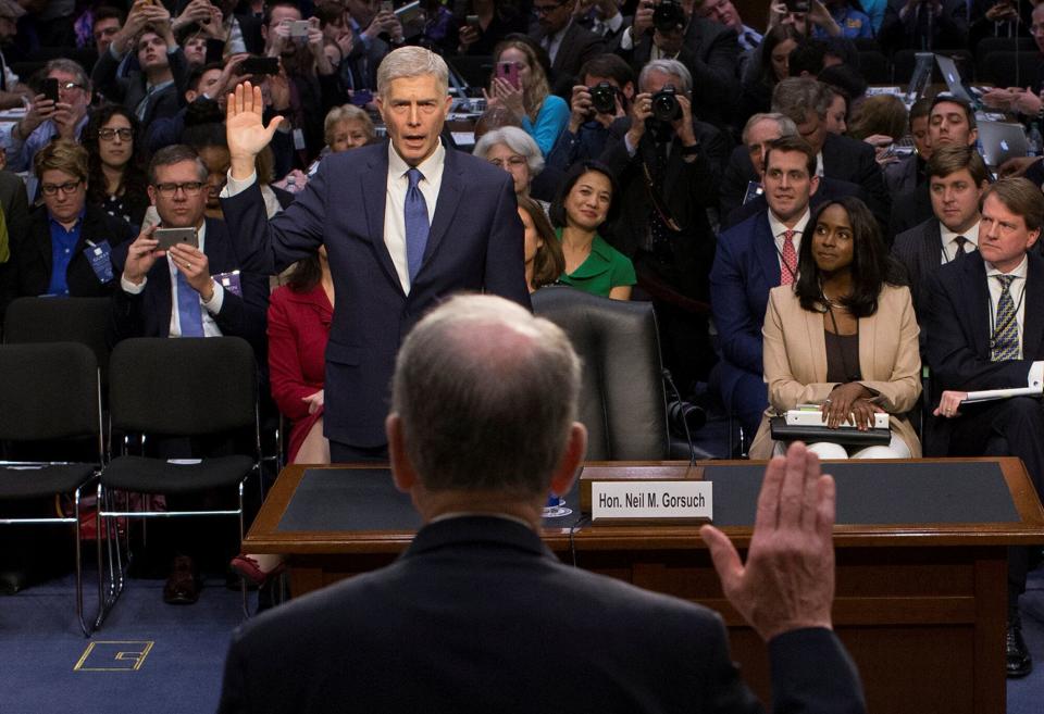 Mary Elizabeth Taylor, right, observes as Senate Judiciary Committee Chairman Chuck Grassley (R-Iowa) swears in Neil Gorsuch during the first day of his Supreme Court confirmation hearing on March 20, 2017.