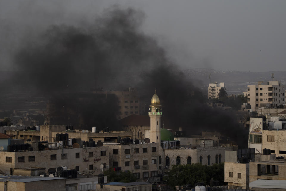 Black smokes rise to the sky during clashes between Israeli forces and Palestinians demonstrators in the West Bank city of Jenin, Wednesday, May 22, 2024. (AP Photo/Leo Correa)