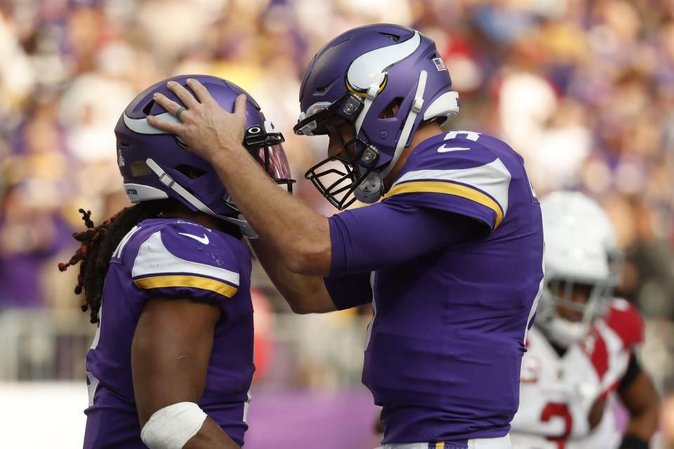 Minnesota Vikings running back Alexander Mattison, left, celebrates with teammate quarterback Kirk Cousins (8) after scoring on a 7-yard touchdown run during the second half of an NFL football game against the Arizona Cardinals, Sunday, Oct. 30, 2022, in Minneapolis. (AP Photo/Bruce Kluckhohn)