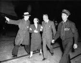 <p>An unidentified woman survivor is being led from the scene of the Hindenburg disaster at the U.S. Naval Station in Lakehurst, N.J., May 6, 1937. (AP Photo/Murray Becker) </p>