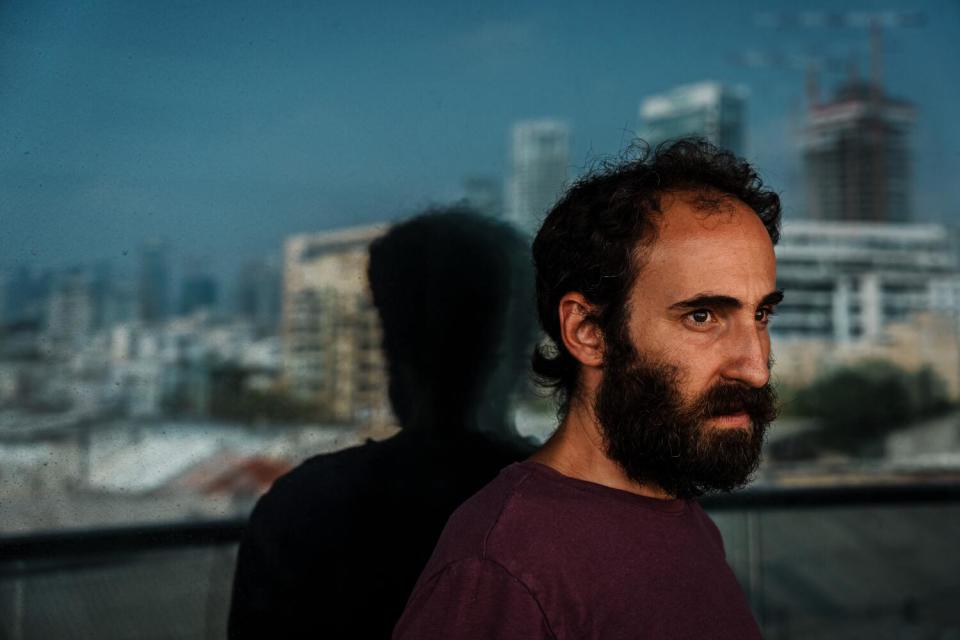 Yonatan Zeigen posing for a portrait at his Tel Aviv home