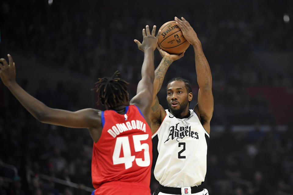 Los Angeles Clippers forward Kawhi Leonard, right, shoots as Detroit Pistons forward Sekou Doumbouya defends during the first half of an NBA basketball game Thursday, Jan. 2, 2020, in Los Angeles. (AP Photo/Mark J. Terrill)