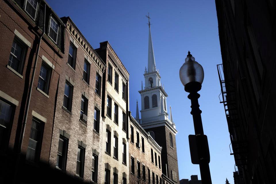 In this Wednesday, Nov. 7, 2018 photo Old North Church stands among buildings in the North End neighborhood of Boston. A memorial honoring fallen soldiers from the U.S. and Britain is being dedicated this month at an ironic venue - the Boston church where America's war for independence from England basically began. On Nov. 17, British and American military brass will unveil a bronze wreath and plaque at Old North Church, saluting troops from both countries who have died in Iraq and Afghanistan. (AP Photo/Steven Senne)