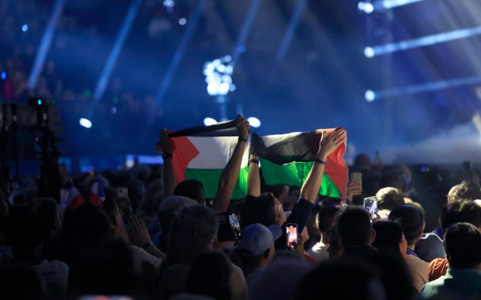 Palestinian flags are held up in the crowd during the final dress rehearsal on Saturday