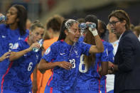 FILE - France's Selma Bacha throws water on her face as France's manager Corinne Diacre talks with her during a cooling break during the Women Euro 2022 quarterfinals soccer match between France and the Netherlands at the New York Stadium in Rotherham, England, Saturday, July 23, 2022. (AP Photo/Jon Super, File)