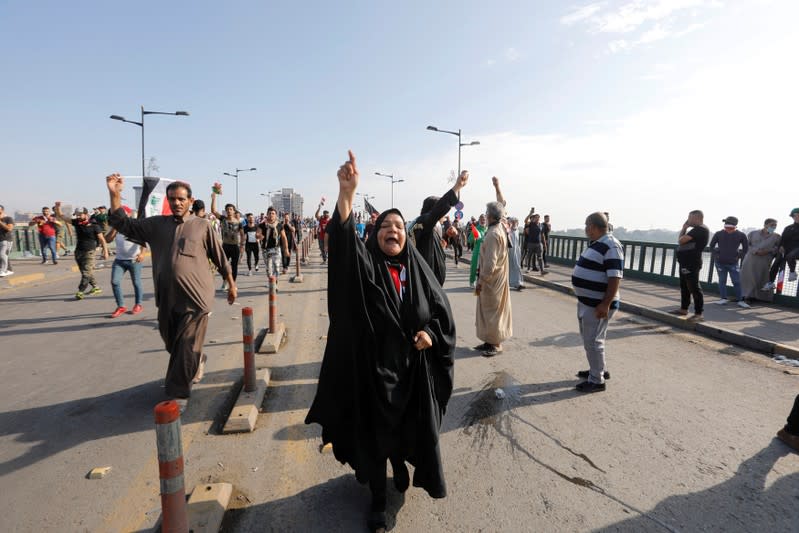 A woman shouts slogans during a protest over corruption, lack of jobs, and poor services, in Baghdad