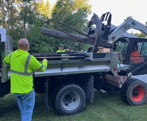 City of Sturgeon Bay workers load the 1,000-pound anchor of the Oak Leaf, a barge that sank at Bullhead Point in Sturgeon Bay in 1928, to move it from its longtime location at Eagle Bluff Lighthouse in Peninsula State Park back to Bullhead Point.