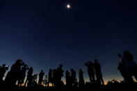 People watch the total solar eclipse from Clingmans Dome, which at 6,643 feet (2,025m) is the highest point in the Great Smoky Mountains National Park, Tennessee, U.S. August 21, 2017. Location coordinates for this image are 35º33'24" N, 83º29'46" W. REUTERS/Jonathan Ernst