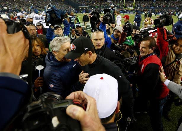 SEATTLE, WA - JANUARY 19:  Head coach Pete Carroll of the Seattle Seahawks and head coach Jim Harbaugh of the San Francisco 49ers shake hands after the Seahawks 23-17 victory during the 2014 NFC Championship at CenturyLink Field on January 19, 2014 in Seattle, Washington.  (Photo by Tom Pennington/Getty Images)