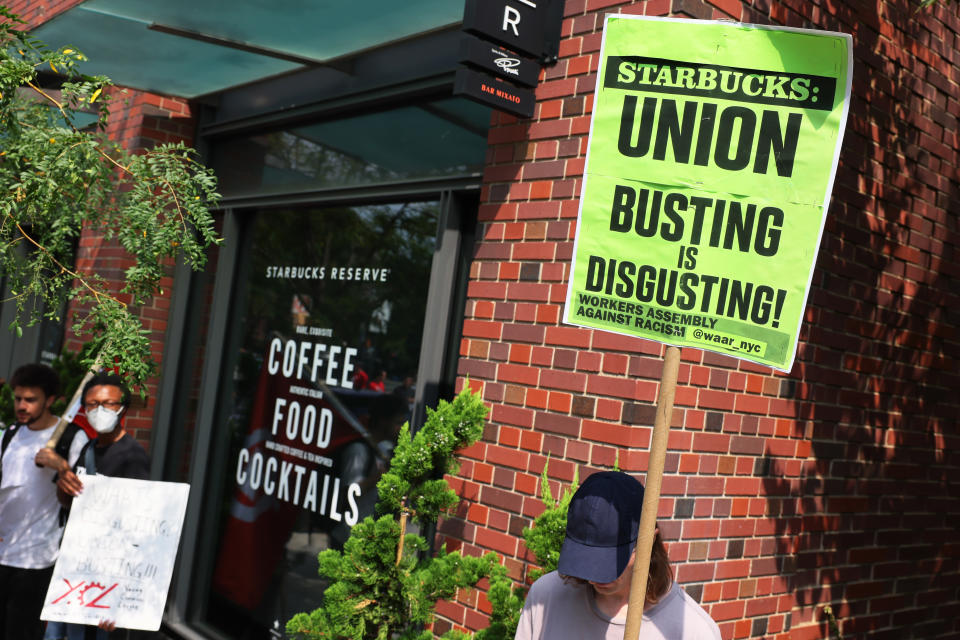 NEW YORK, NEW YORK - SEPTEMBER 05: Pro-union protestors hold signs during a rally near the home of Starbucks’ interim CEO Howard Schultz on September 05, 2022 in New York City. Members of the Amazon Labor Union (ALU) led by Christian Smalls, President of the ALU, and Amazon workers were joined by Starbucks workers, community organizations and pro-union protestors for a Labor Day March for Recognition demanding their unions be recognized by Amazon and Starbucks. The protestors gathered at the NYC homes of Starbucks’ interim CEO Howard Schultz and Amazon CEO Jeff Bezos before holding a rally in Times Square. (Photo by Michael M. Santiago/Getty Images)