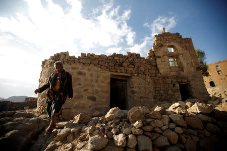 A man walks near his house destroyed in an air strike carried out by the Saudi-led coalition in Faj Attan village, Sanaa, Yemen December 13, 2018. REUTERS/Mohamed al-Sayaghi