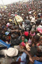 <p>Haitians surge the gates at a food distribution point in the Cite Soleil neighborhood in the aftermath of the Jan. 12 earthquake in Port-au-Prince, Tuesday, Jan. 26, 2010. (Photo: Gerald Herbert/AP) </p>