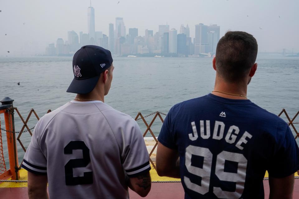 Staten Island Ferry commuters take in the view of lower Manhattan seen through haze, Tuesday, July 20, 2021, in New York. Smoke from wildfires across the U.S. West, including Oregon's Bootleg Fire, has wafted over large swaths of the eastern United States.