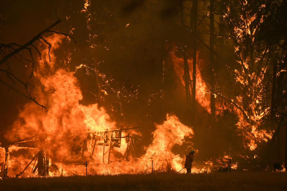 Fire crews fight the Gospers Mountain Fire as it impacts a structure at Bilpin. 