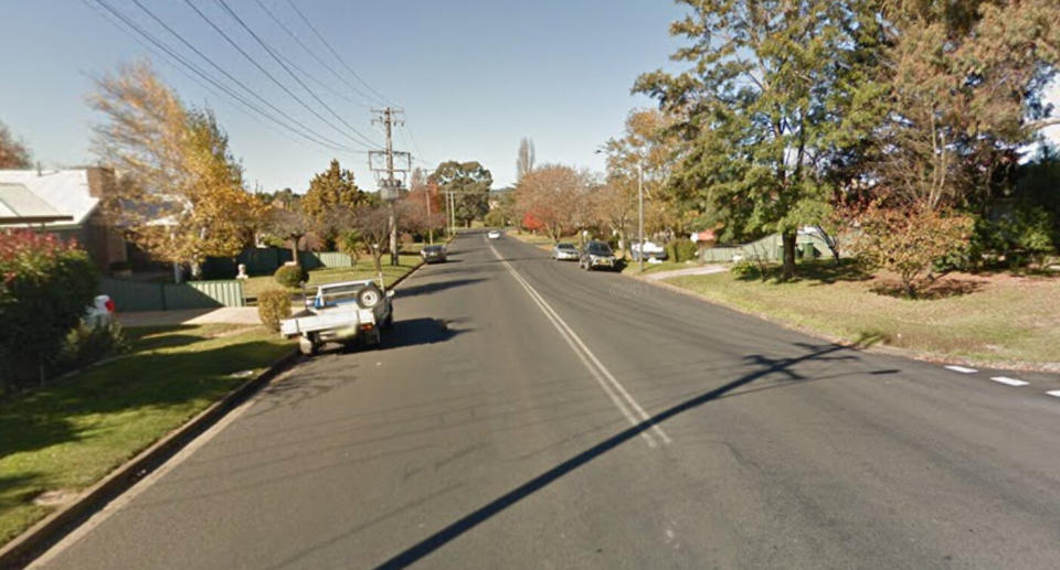 Cars are parked on the side of Racecourse Road in Orange, NSW, where a woman copped a fine for parking on her lawn.