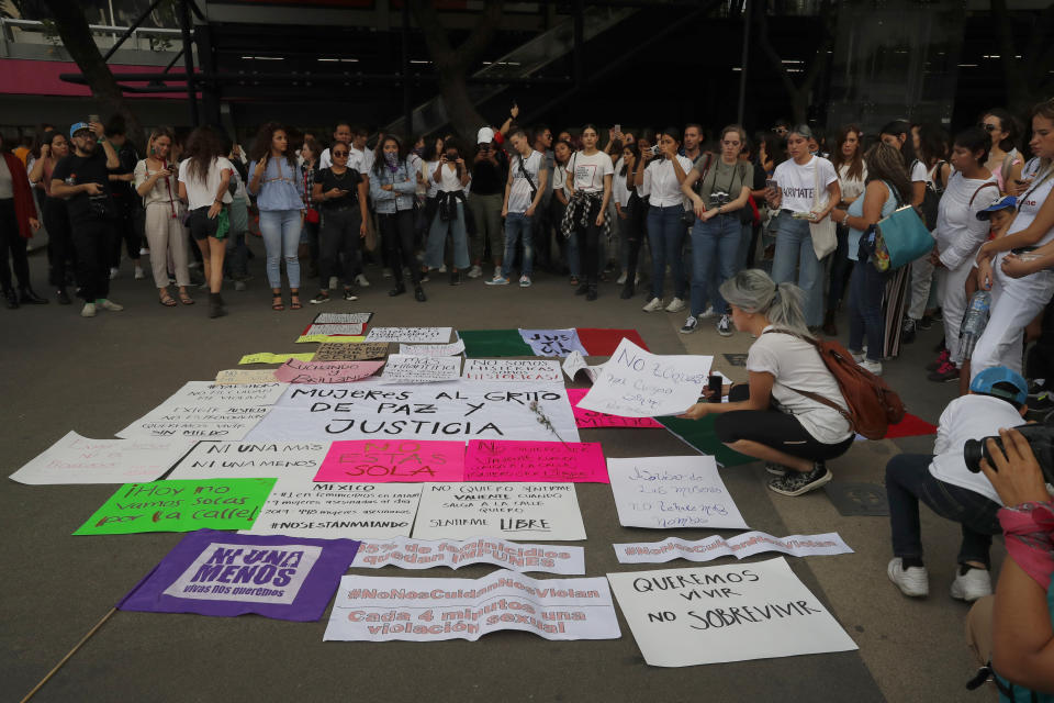 Women stand in a circle as they gather for a protest march to demand justice and for their safety, sparked by two recent alleged rapes by police, in Mexico City, Friday, Aug. 16, 2019. (AP Photo/Marco Ugarte)