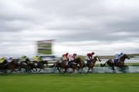Horses run in the William Hill Handicap Hurdle race on the third day of the Grand National Horse Racing meeting at Aintree racecourse, near Liverpool, England, Saturday, April 13, 2024. Organizers of Britain's biggest horse race have taken action to improve safety and avoid a repeat of the chaos sparked by animal-rights activists before last year's edition.(AP Photo/Dave Shopland)