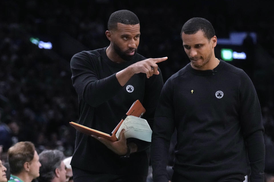 Boston Celtics assistant coach Charles Lee, left, talks with head coach Joe Mazzulla during the first half of Game 1 of an NBA basketball second-round playoff series against the Cleveland Cavaliers, Tuesday, May 7, 2024, in Boston. The Charlotte Hornets named Charles Lee as their head coach on Thursday, May 9, 2024, hoping he'll turn around the long-struggling NBA franchise. The 39-year-old Lee joins the Hornets after serving as the Boston Celtics top assistant coach. Lee will complete the Celtics’ playoff run before joining the Hornets on a full-time basis. (AP Photo/Charles Krupa)