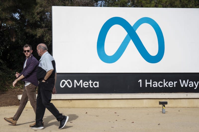 People walk by a sign on the Meta campus In Menlo Park, Calif., in 2022. On Tuesday, users on the three platforms owned by Meta experienced an hourslong glitch affecting half a million users. File Photo by Terry Schmitt/UPI