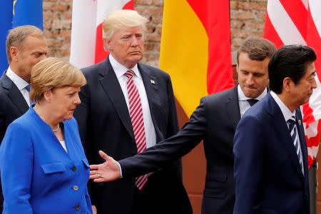 FILE PHOTO: From L-R, European Council President Donald Tusk, German Chancellor Angela Merkel, U.S. President Donald Trump, French President Emmanuel Macron and Japanese Prime Minister Shinzo Abe walk after a family photo during the G7 Summit in Taormina, Sicily, Italy, May 26, 2017. REUTERS/Jonathan Ernst/File Photo