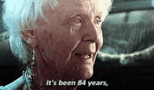 Elderly woman in a film with subtitle "It's been 84 years," expressing reminiscence