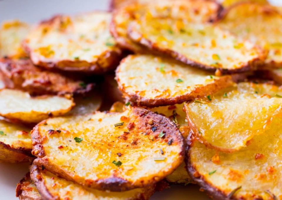 <p>Whole and Heavenly Oven</p><p>Crispy smashed red potatoes are drizzled in a flavorful basil pesto and topped with lots of Parmesan cheese for an easy and addicting side dish!</p><p><strong>Get the recipe: <a href="https://wholeandheavenlyoven.com/2018/01/17/parmesan-basil-pesto-smashed-red-potatoes/" rel="nofollow noopener" target="_blank" data-ylk="slk:Parmesan Basil Pesto Smashed Red Potatoes;elm:context_link;itc:0;sec:content-canvas" class="link ">Parmesan Basil Pesto Smashed Red Potatoes</a></strong></p>